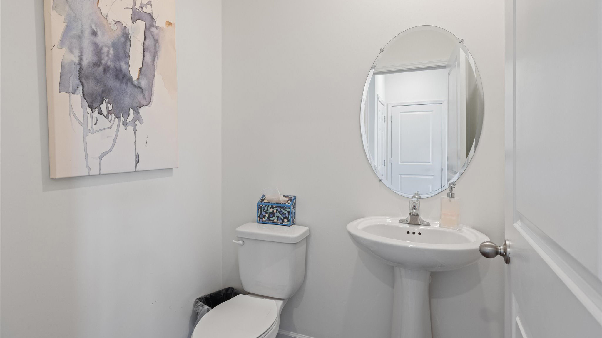 Downstairs guest half bathroom with pedestal sink