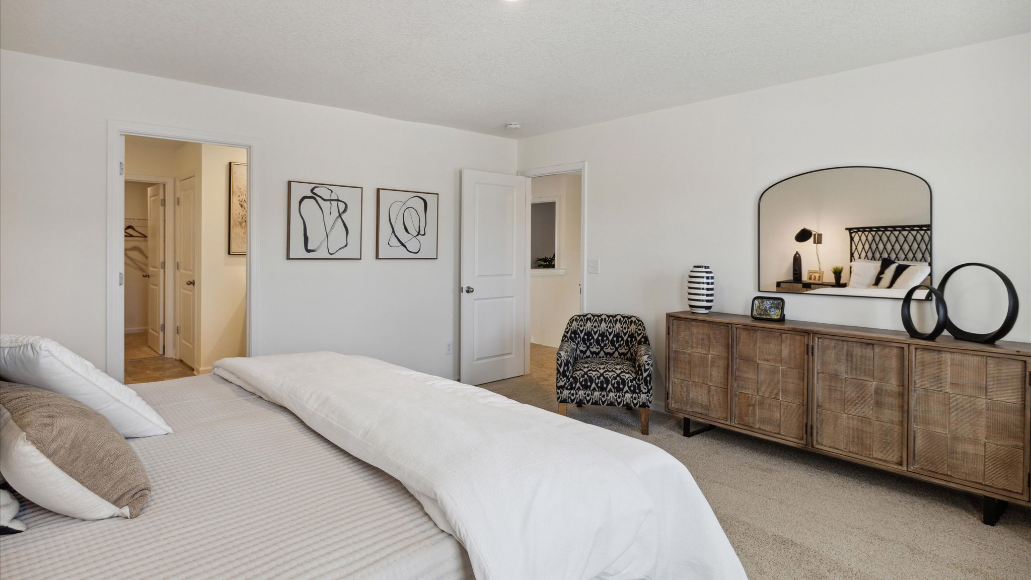 Primary bedroom with plush carpet floors and double light allowing windows
