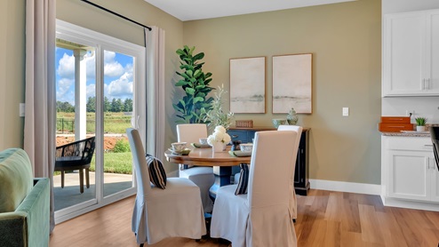 dining room next to the kitchen with a round table with four chairs