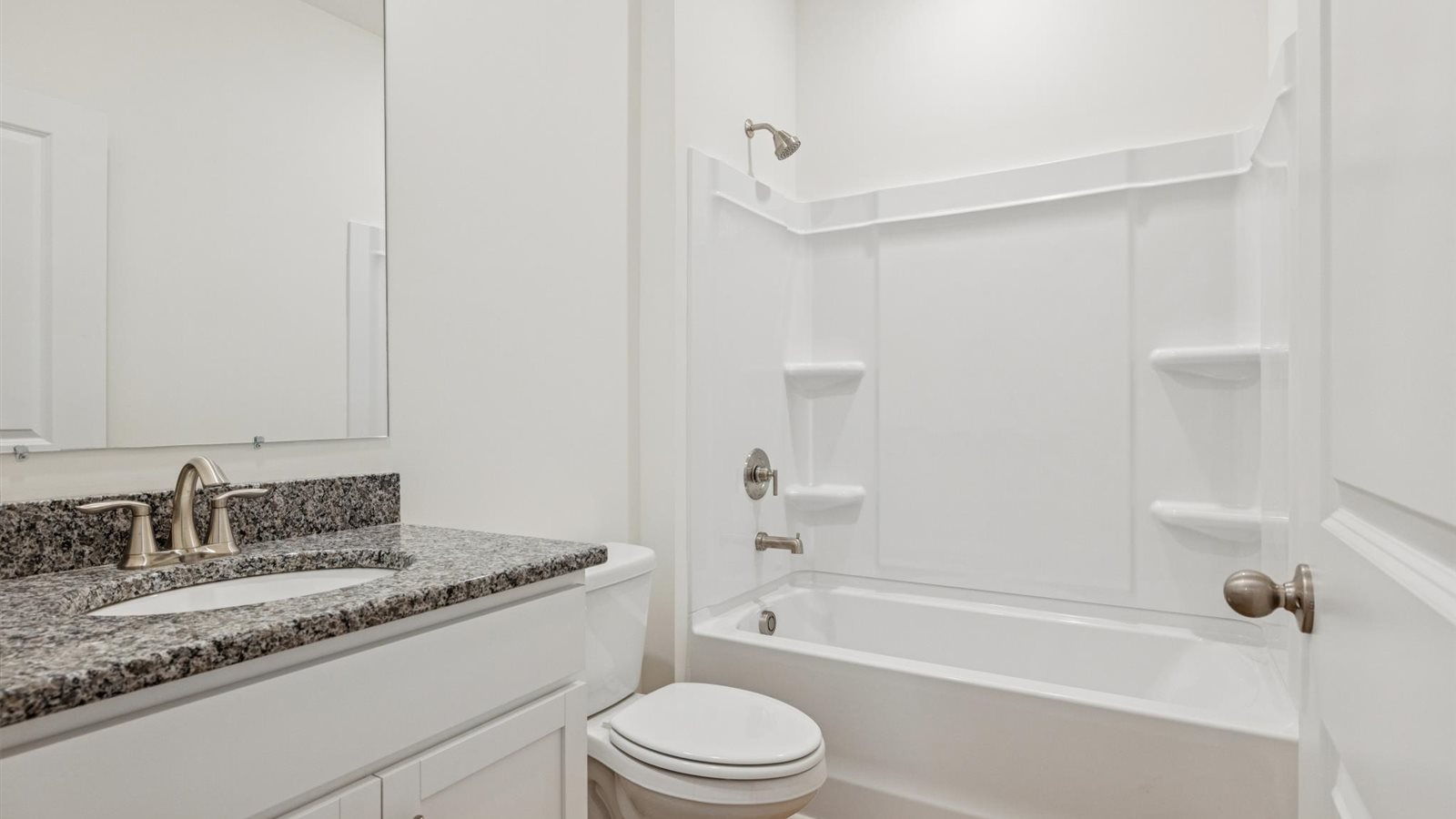Guest bathroom with built in vanity and combination bathtub shower