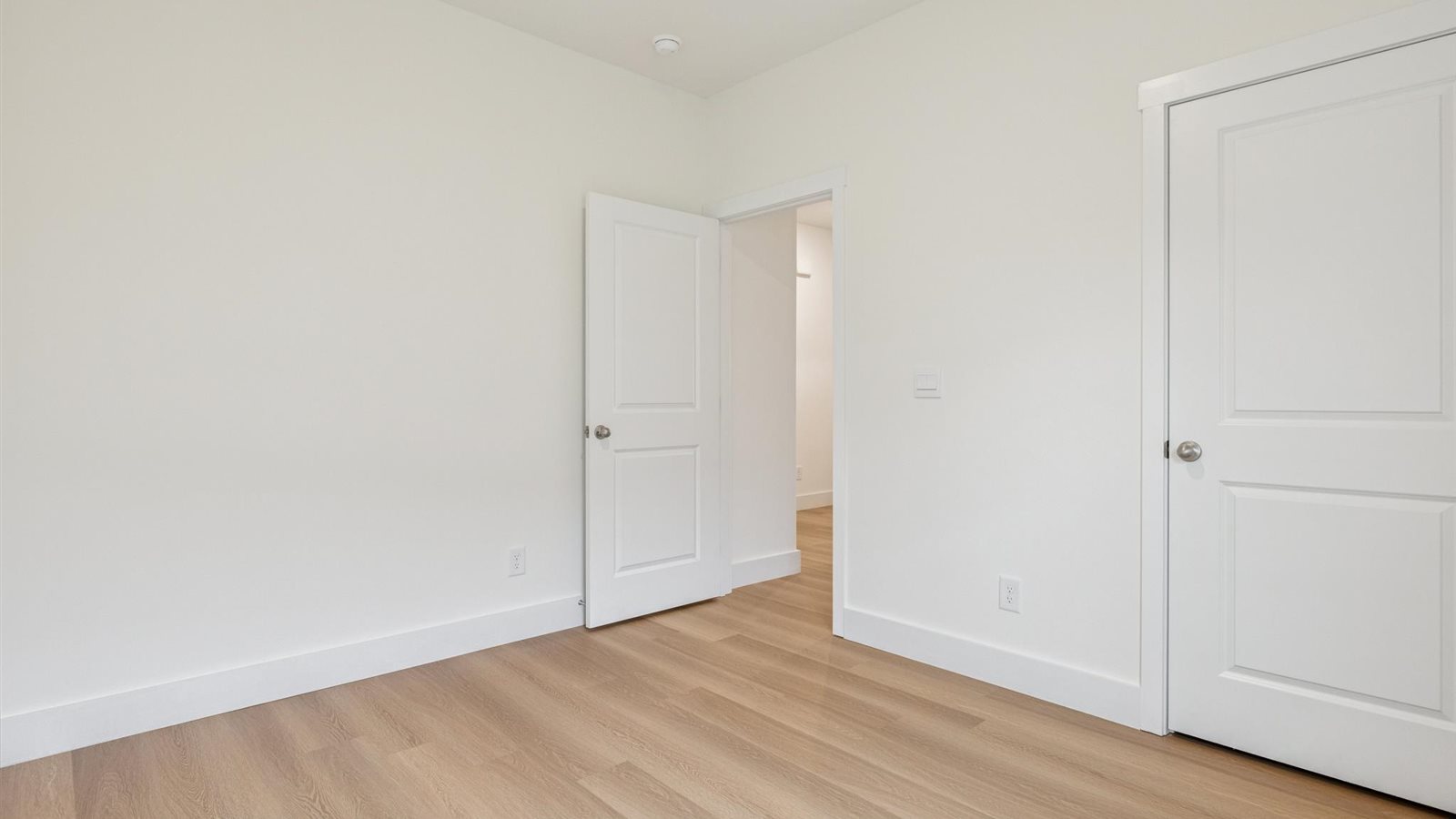 Guest bedroom 1 with front windows and ample natural light