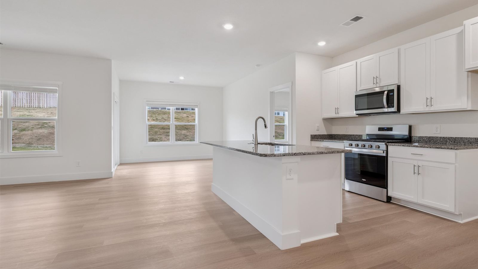 Spacious open concept kitchen with island and counter prep space