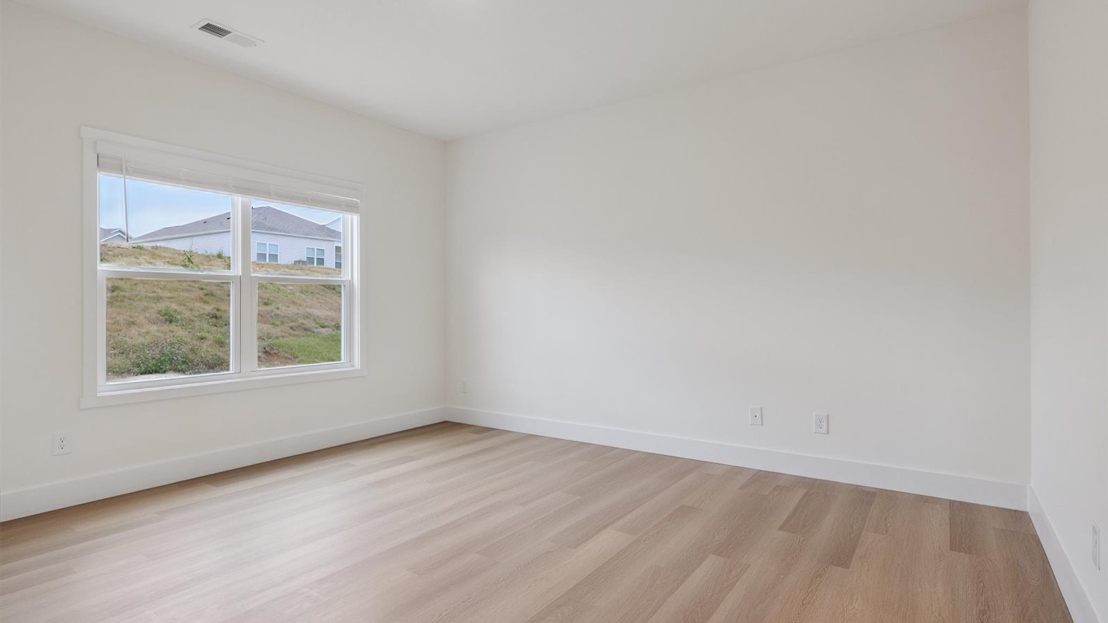 Primary bedroom with private attached bathroom and walk-in closet