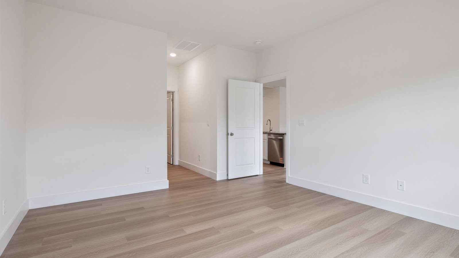 Primary bedroom with private attached bathroom and walk-in closet