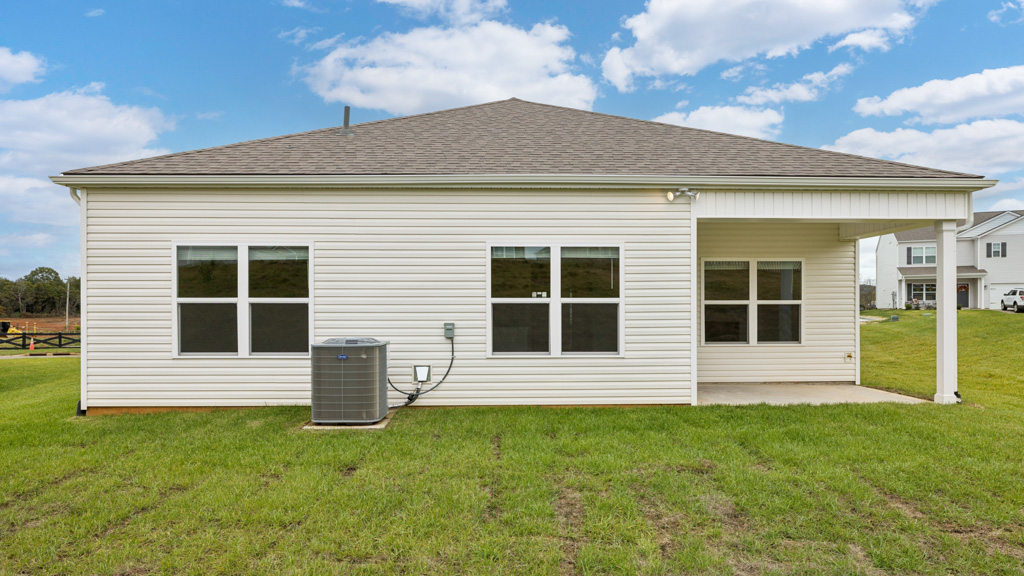 Covered back patio area overlooking private fenced-in backyard