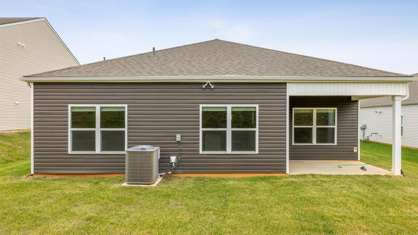 Covered back patio area overlooking private fenced-in backyard