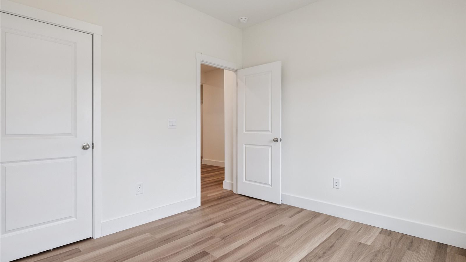 Guest bedroom 1 with front windows and ample natural light