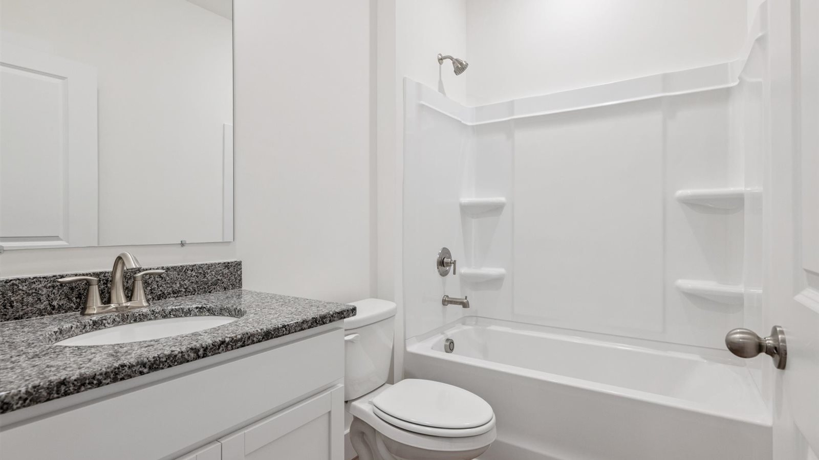 Guest bathroom with built in vanity and combination bathtub shower