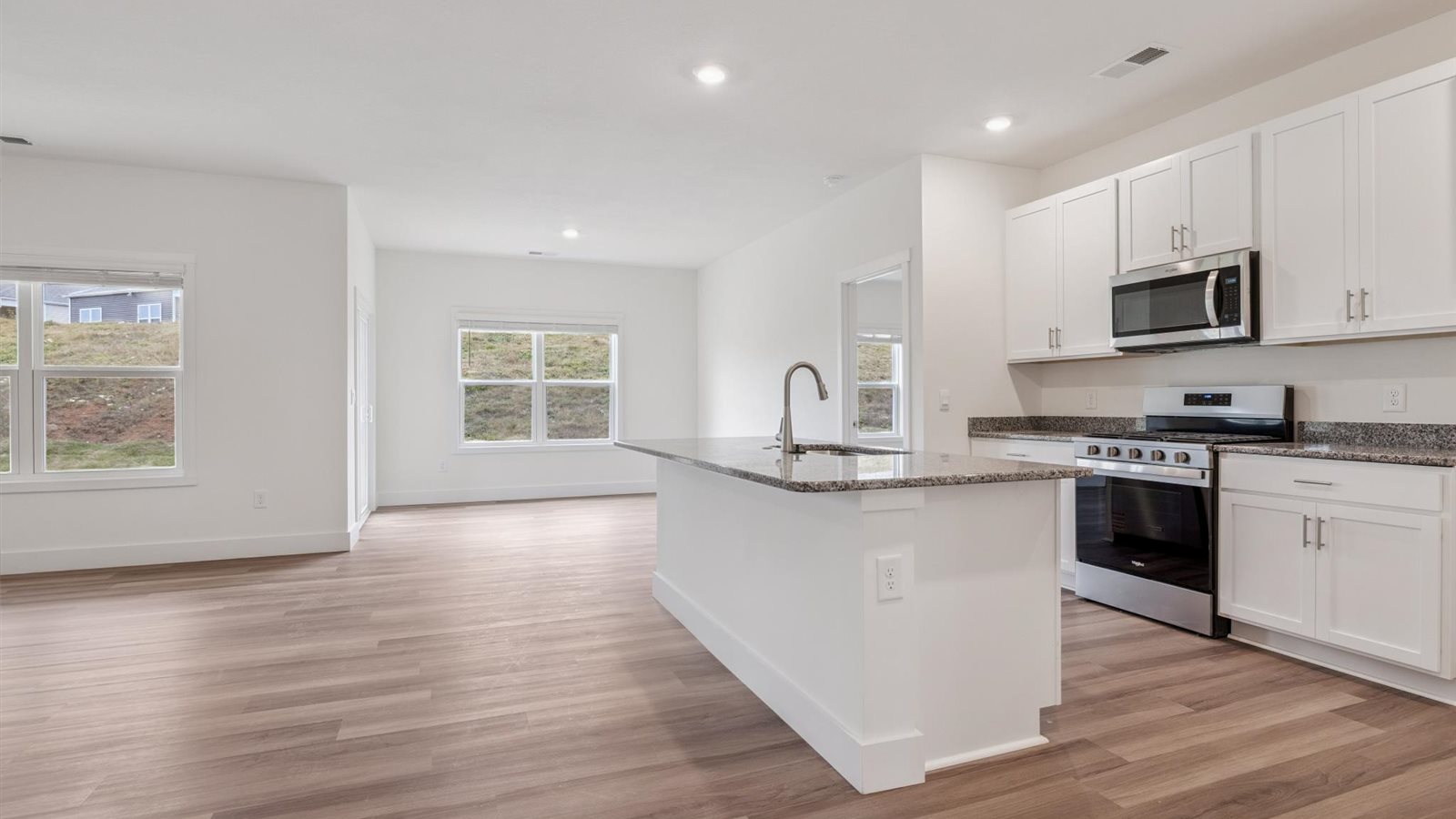 Spacious open concept kitchen with island and counter prep space