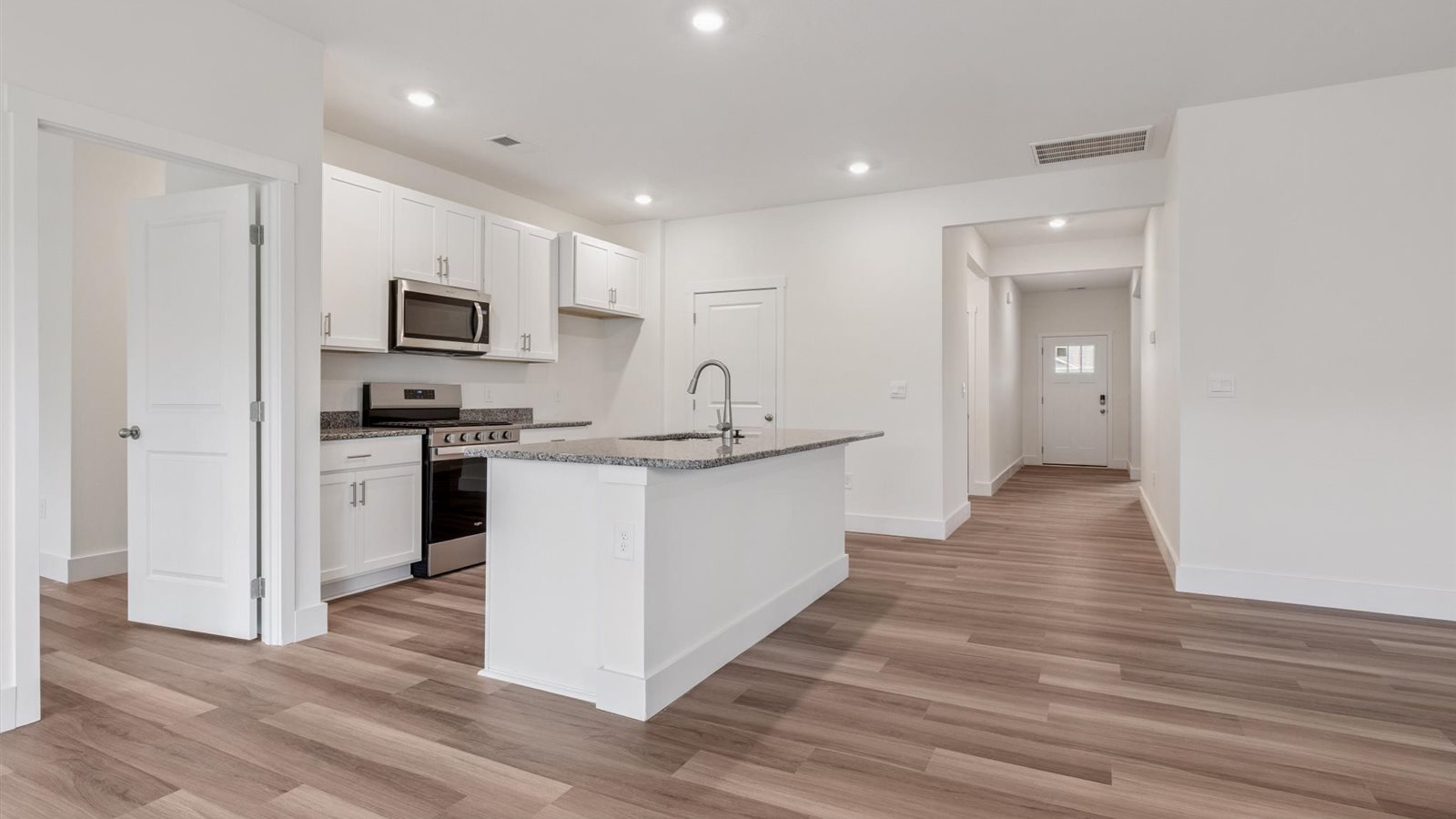 Spacious open concept kitchen with island and counter prep space