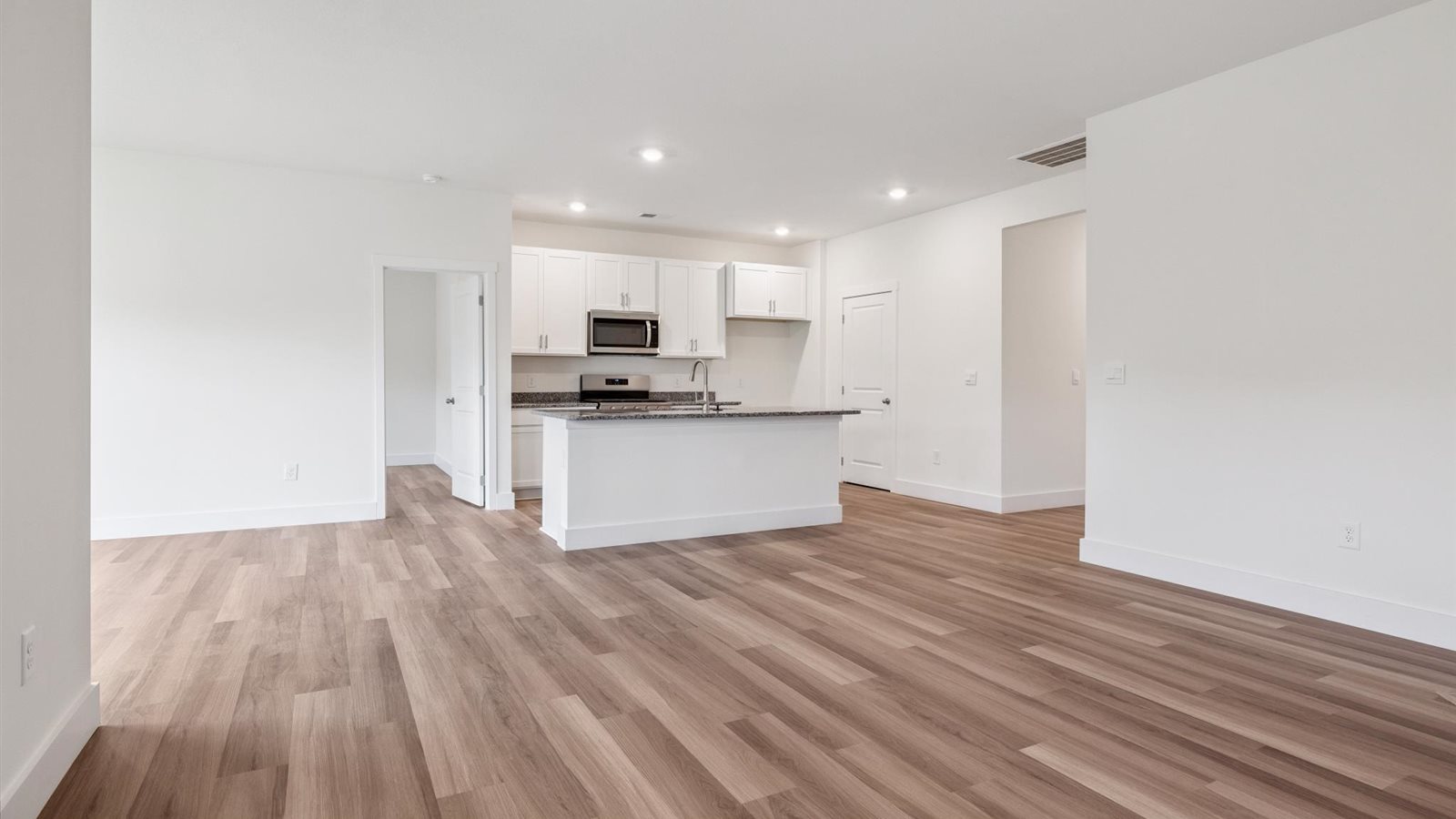 Open concept living, dining, and kitchen space