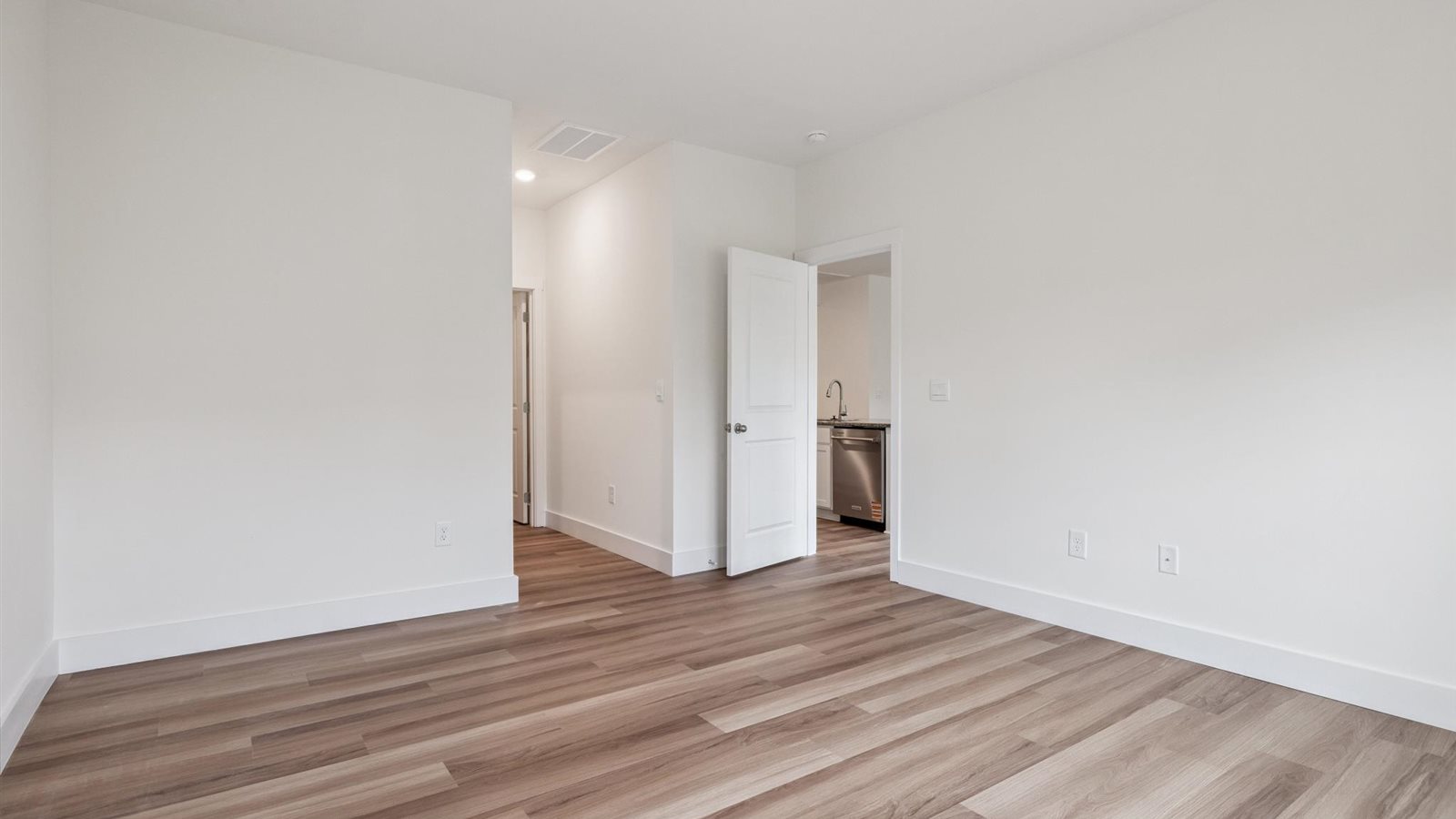 Primary bedroom with private attached bathroom and walk-in closet