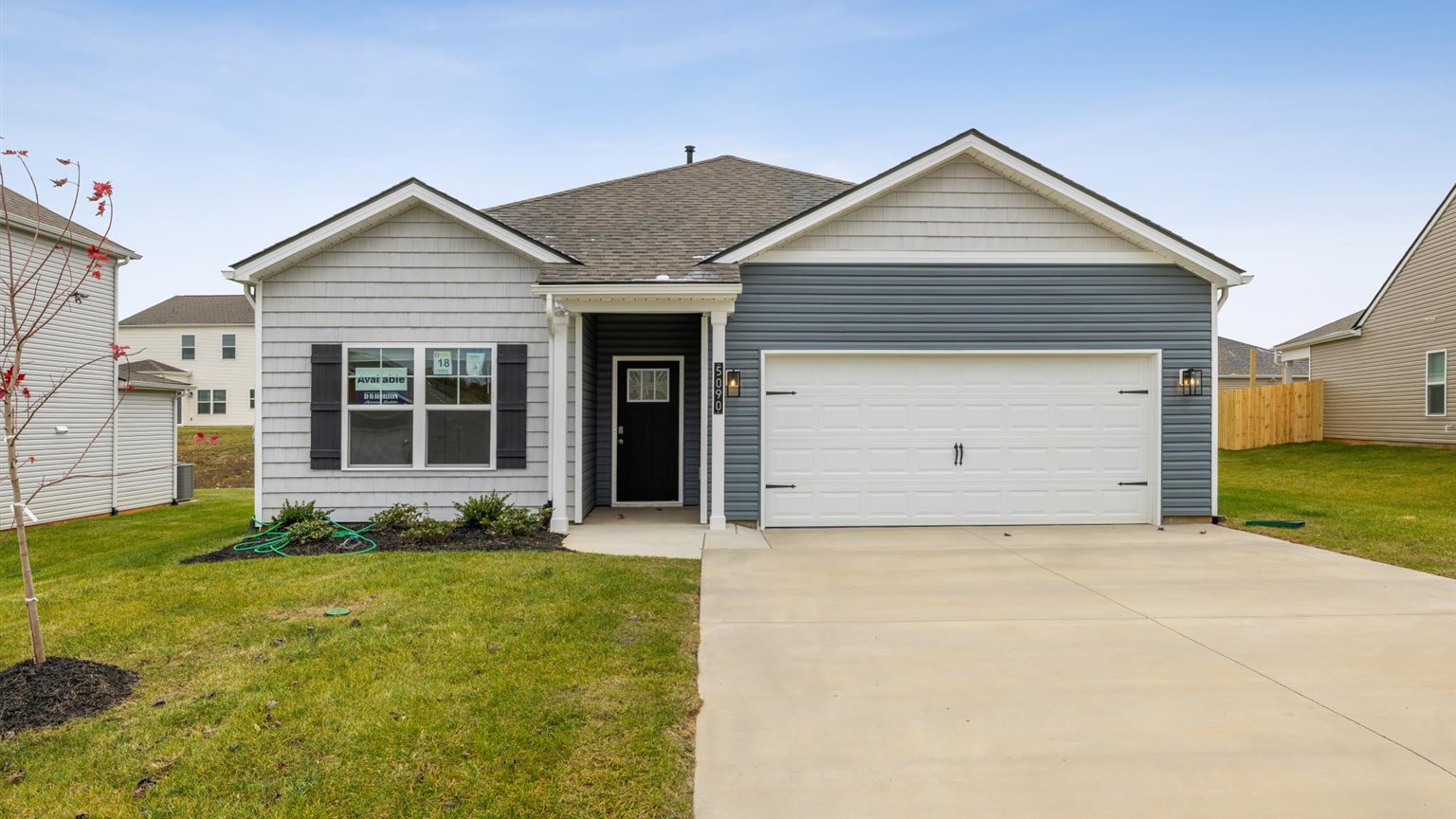 Front exterior of traditional two story home with vinyl and board and batten