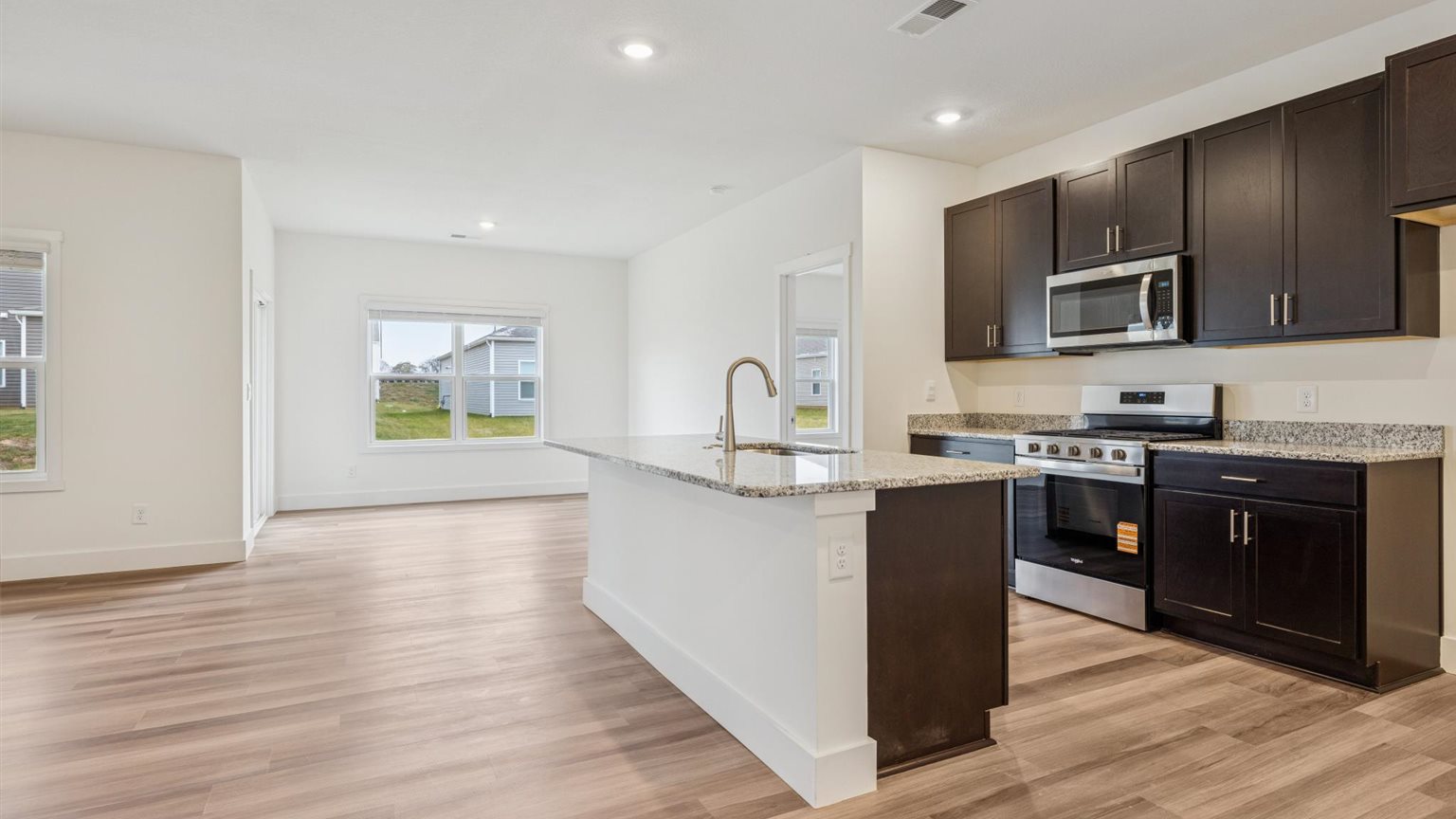 Kitchen with stainless steel appliances, shaker style cabinets, and elevated finishes
