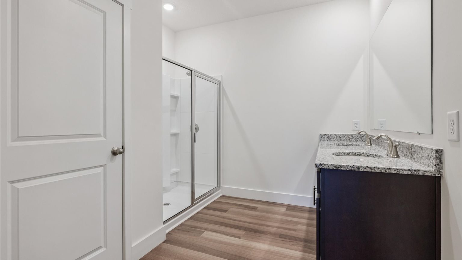 Primary bathroom with double vanity and walk-in shower