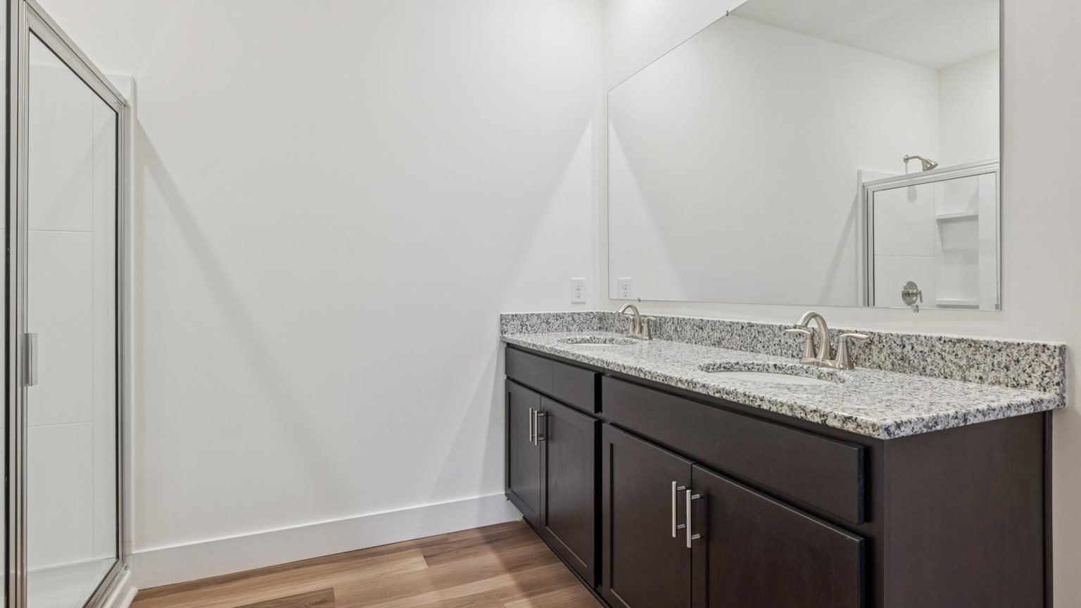 Primary bathroom with double vanity and walk-in shower