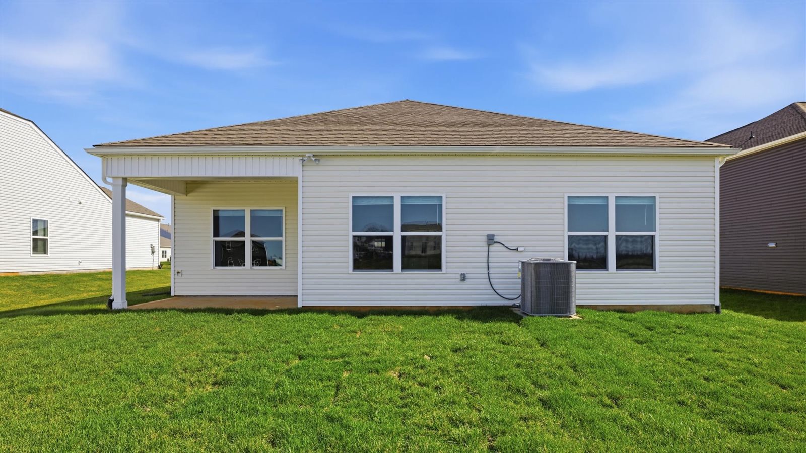 Rear exterior of home and landscaped sodded yard