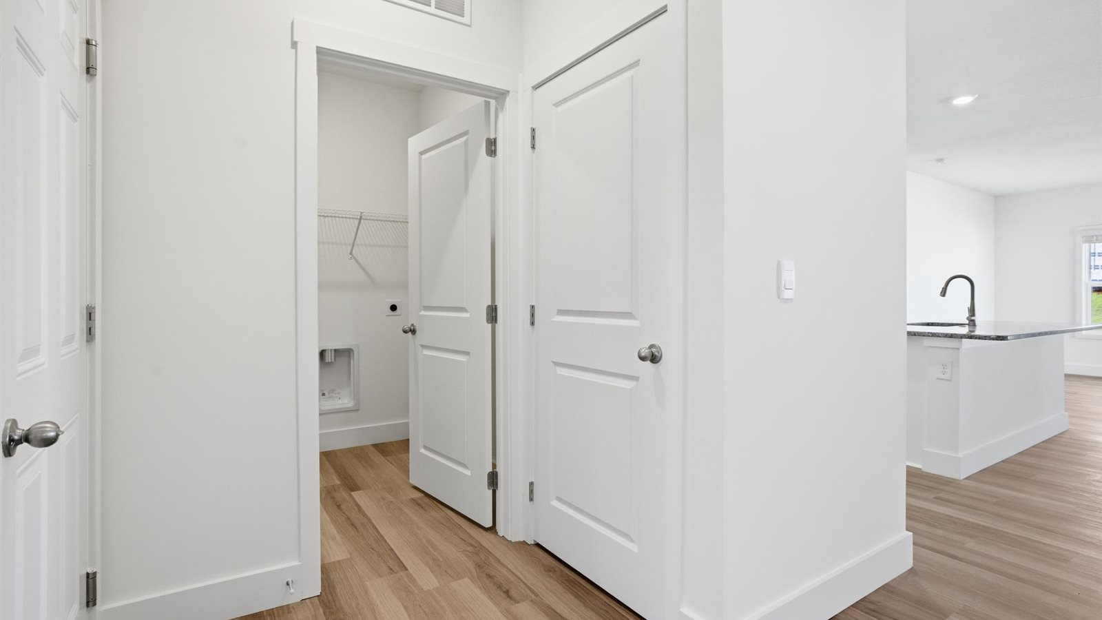 Bright hallway with hardwood flooring