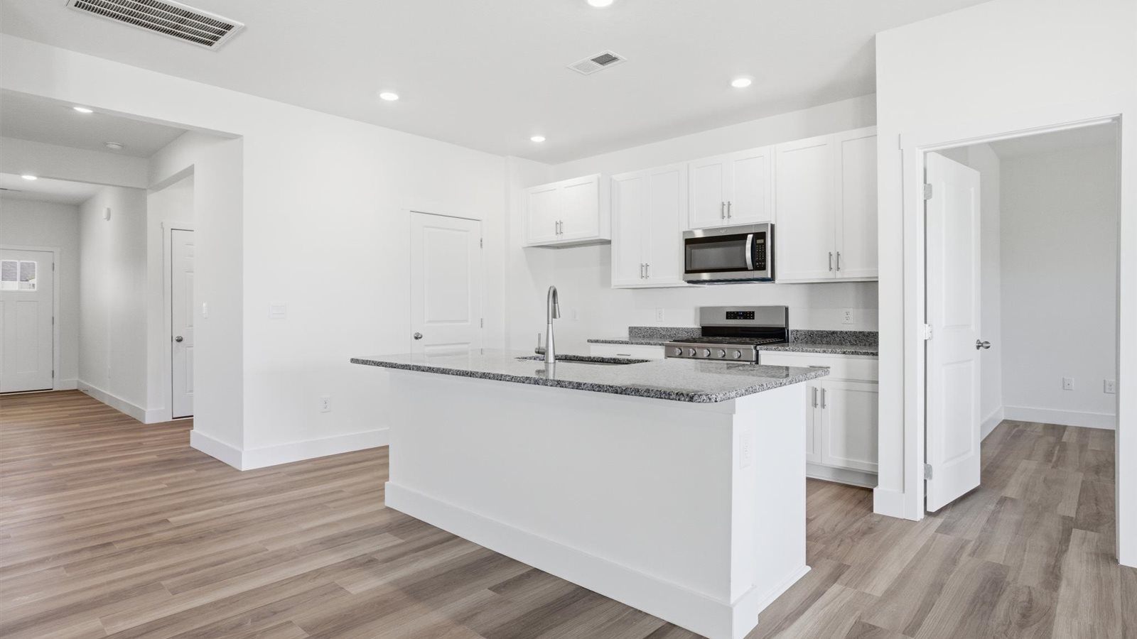 Kitchen with stainless steel appliances, shaker style cabinets, and elevated finishes