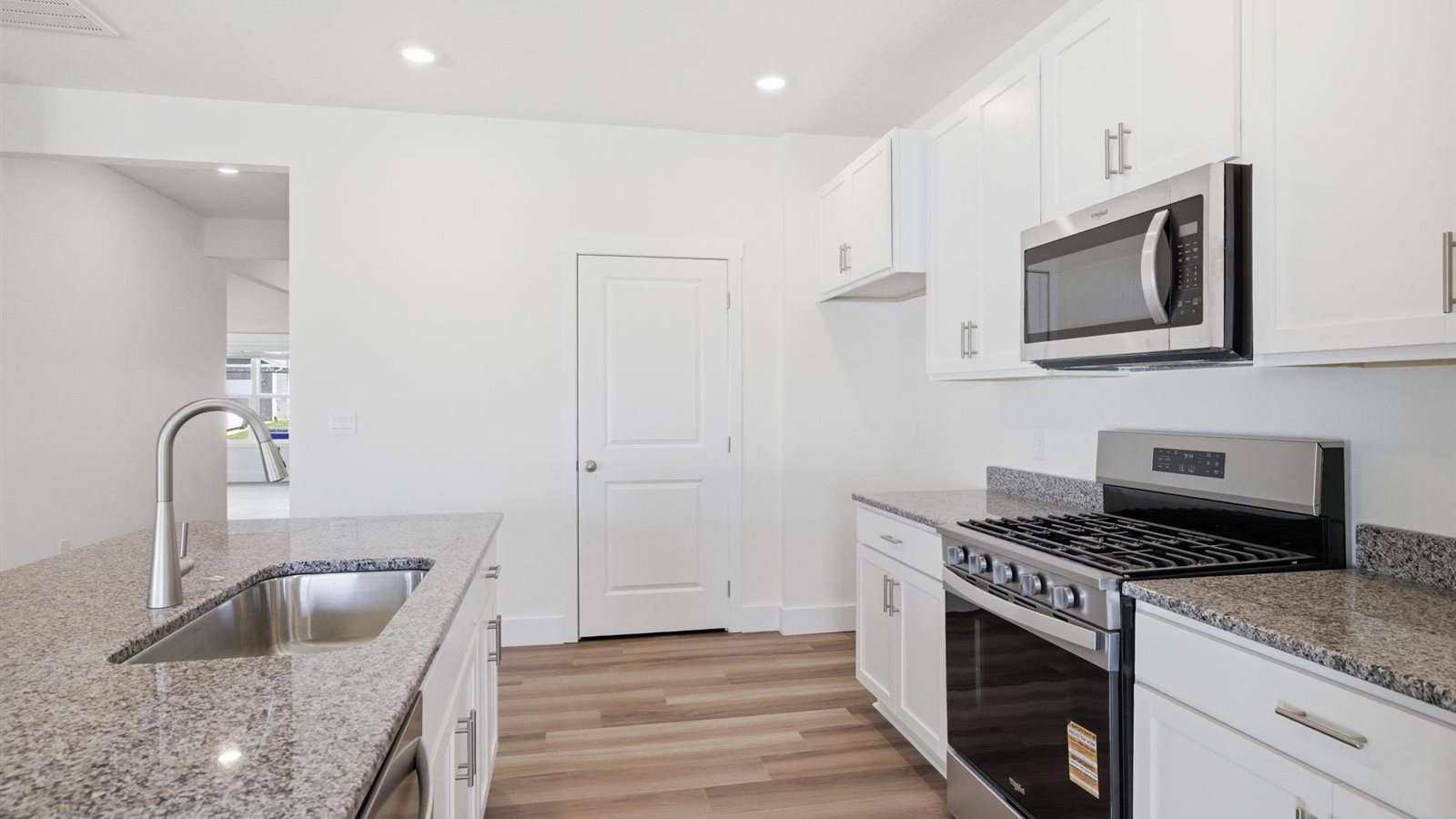 Kitchen with stainless steel appliances, shaker style cabinets, and elevated finishes