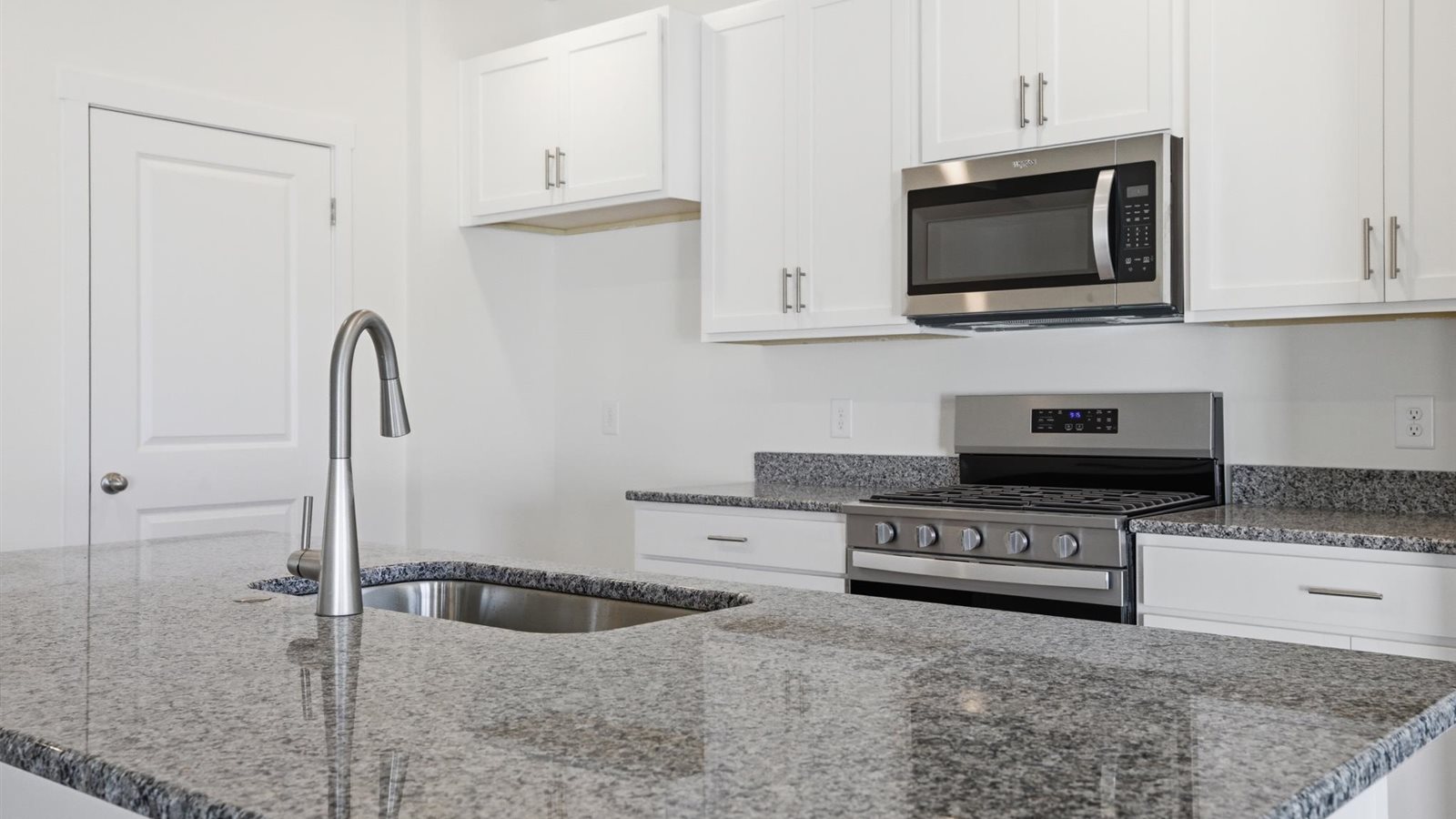 Kitchen with stainless steel appliances, shaker style cabinets, and elevated finishes