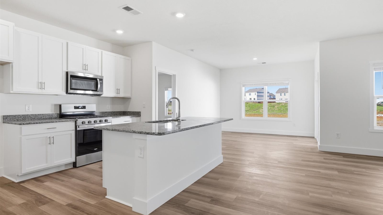 Spacious open concept kitchen with island and counter prep space