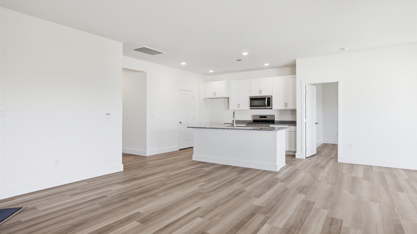 Open concept living, dining, and kitchen space