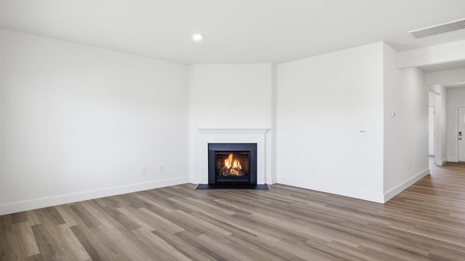 Spacious living and great  room space with light allowing windows