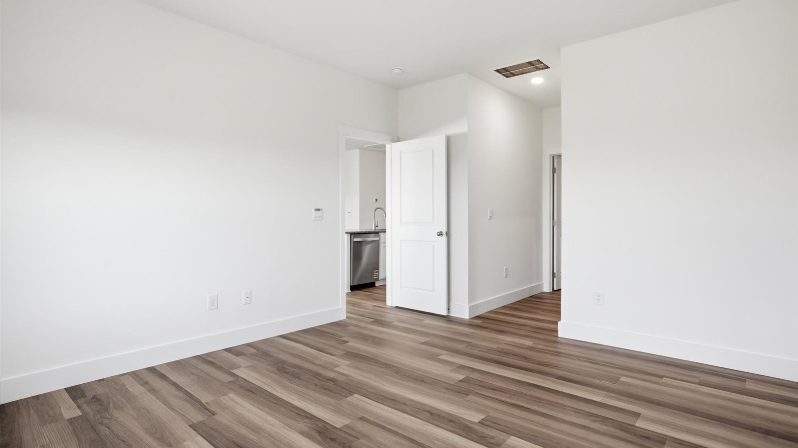 Primary bedroom with private attached bathroom and walk-in closet