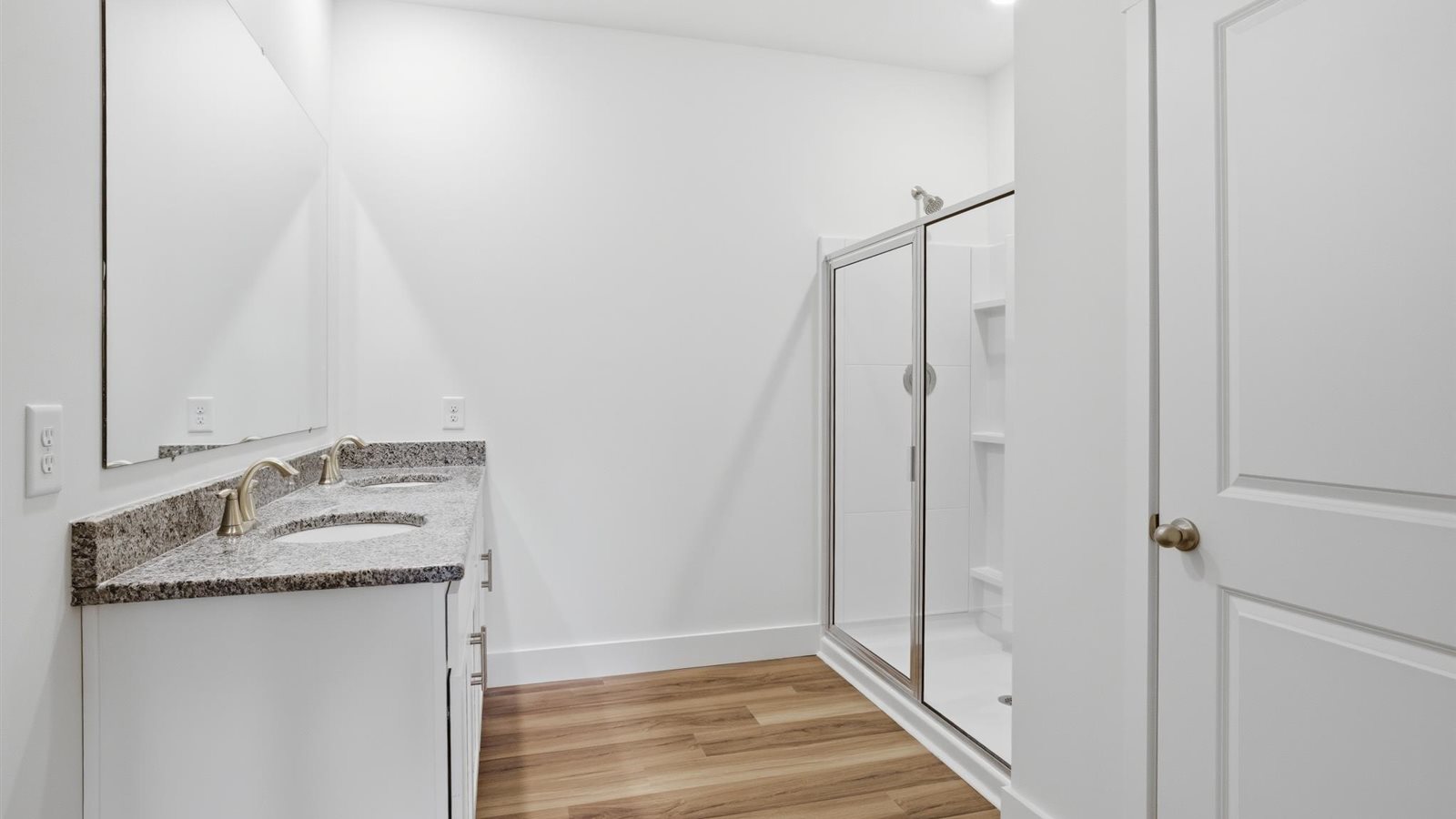 Primary bathroom with double vanity and walk-in shower