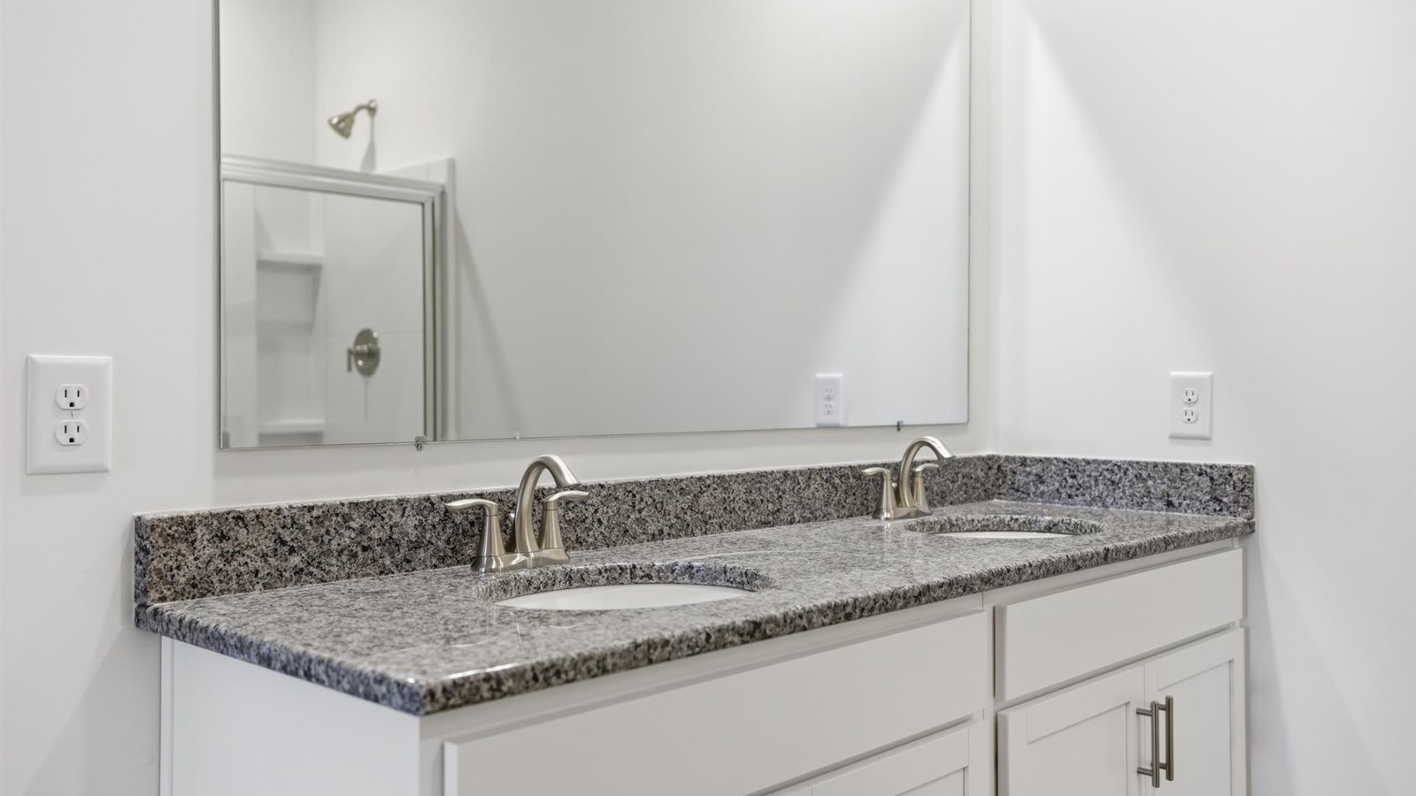 Primary bathroom with double vanity and walk-in shower