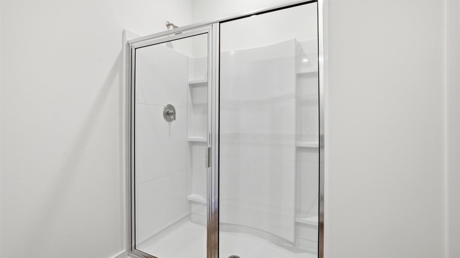 Primary bathroom with double vanity and walk-in shower