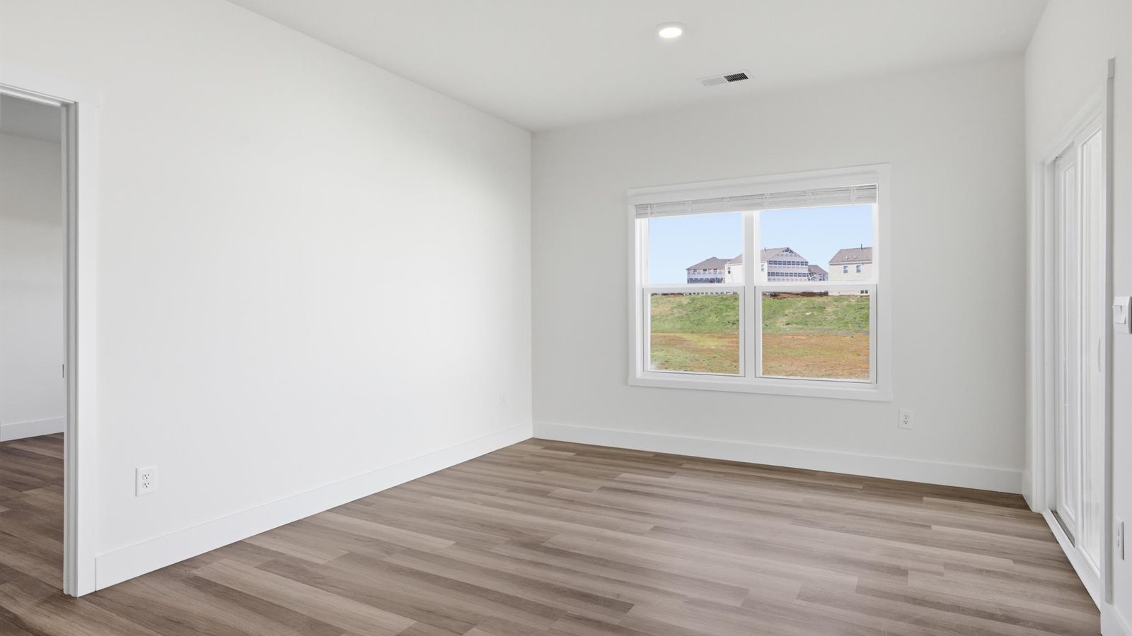 Primary bedroom with private attached bathroom and walk-in closet