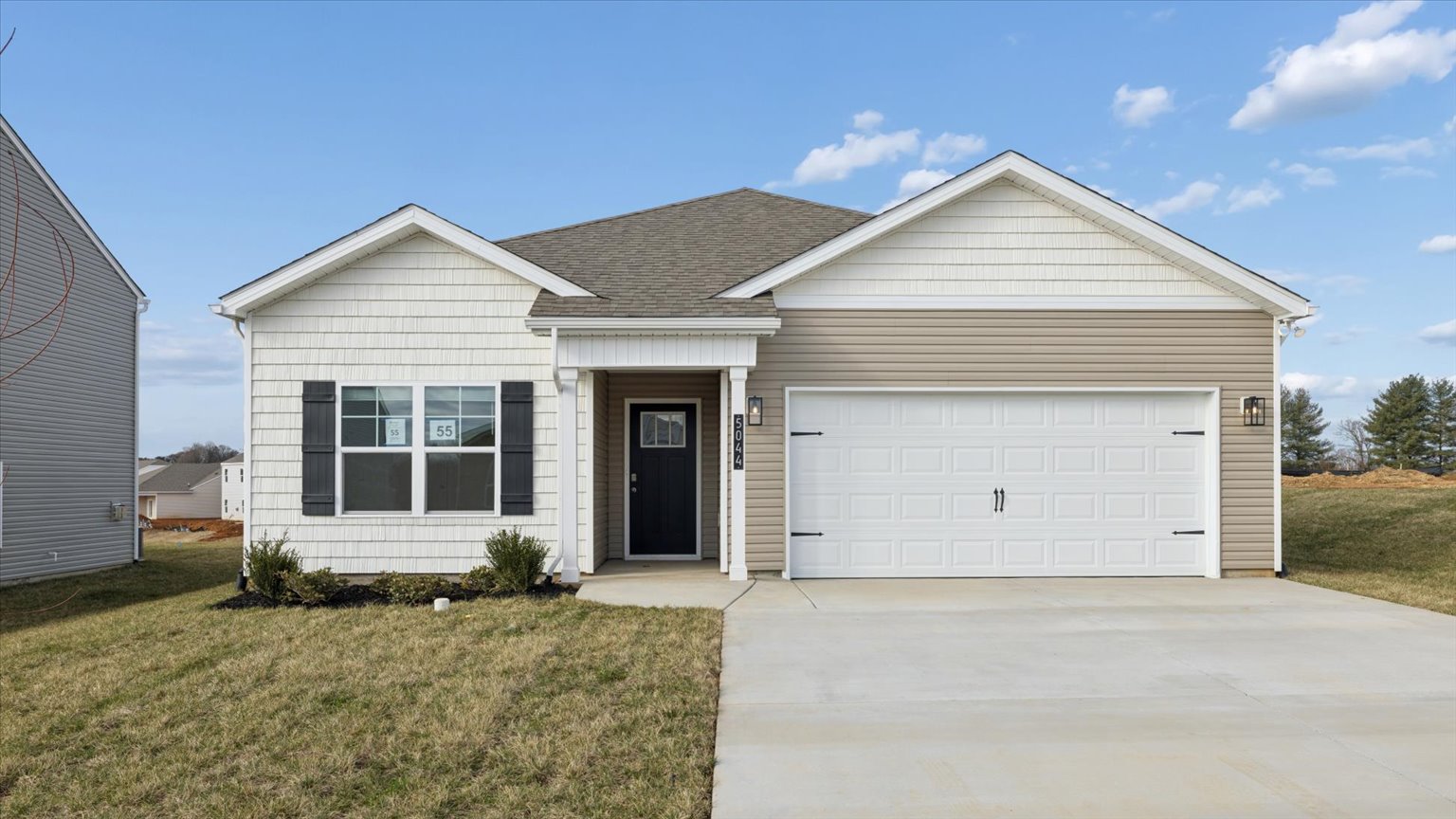 Exterior of single story ranch home with vinyl, shake, and brick