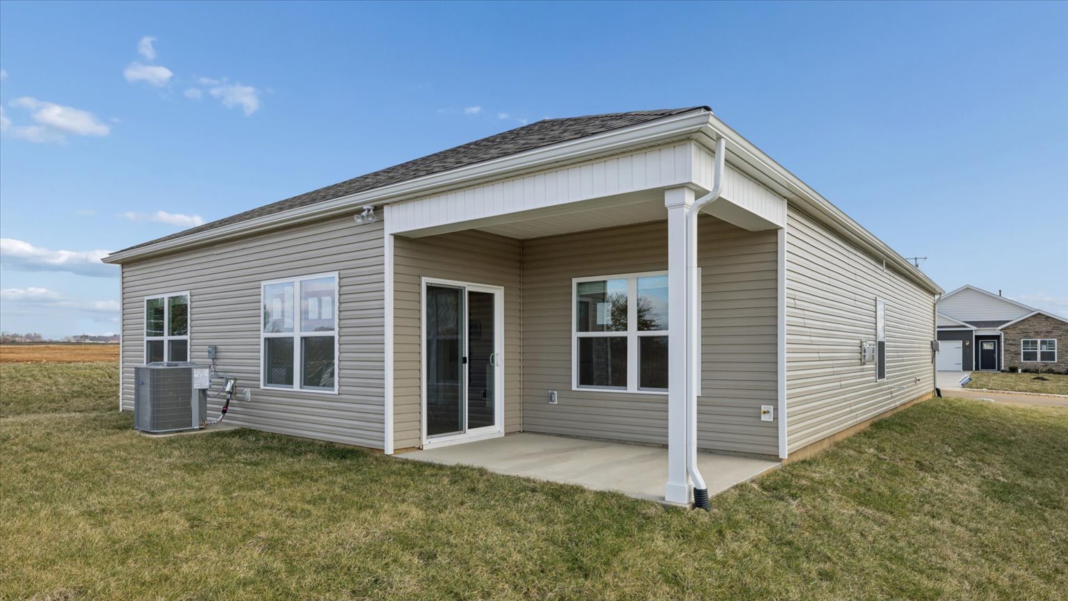 Exterior of single story ranch home with vinyl, shake, and brick
