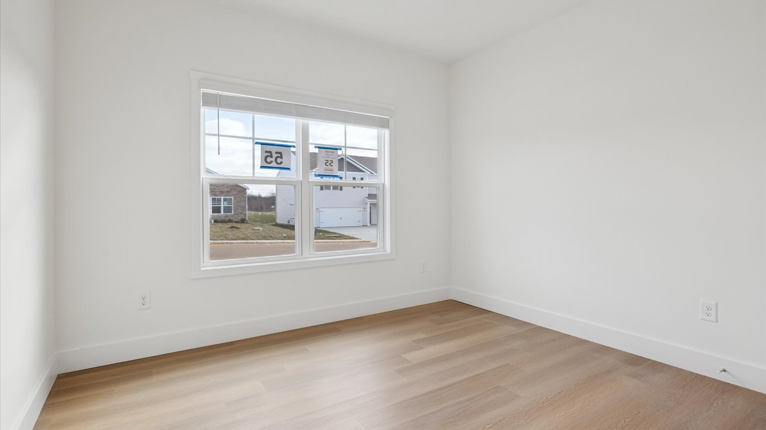Primary bedroom with plush carpet floors and double light allowing windows