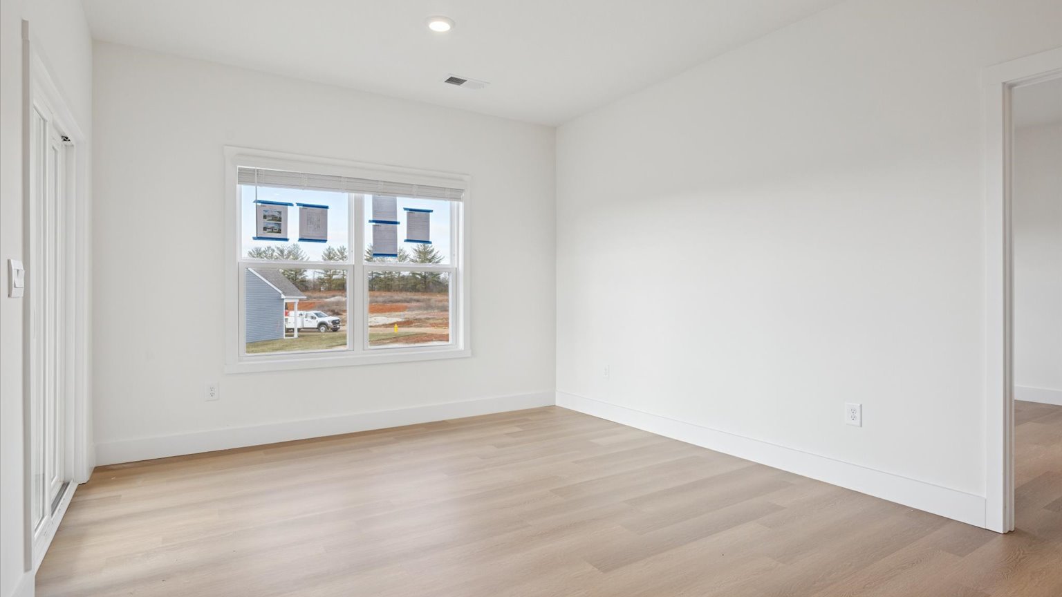 Primary bedroom with plush carpet floors and double light allowing windows