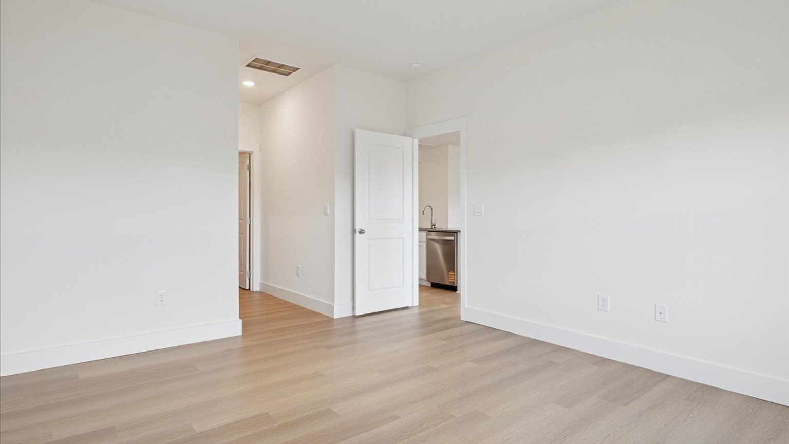 Primary bedroom with plush carpet floors and double light allowing windows