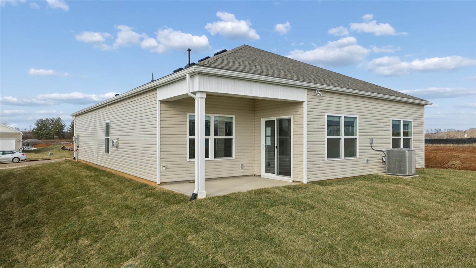 Back exterior of traditional two story home with vinyl, shake, and brick