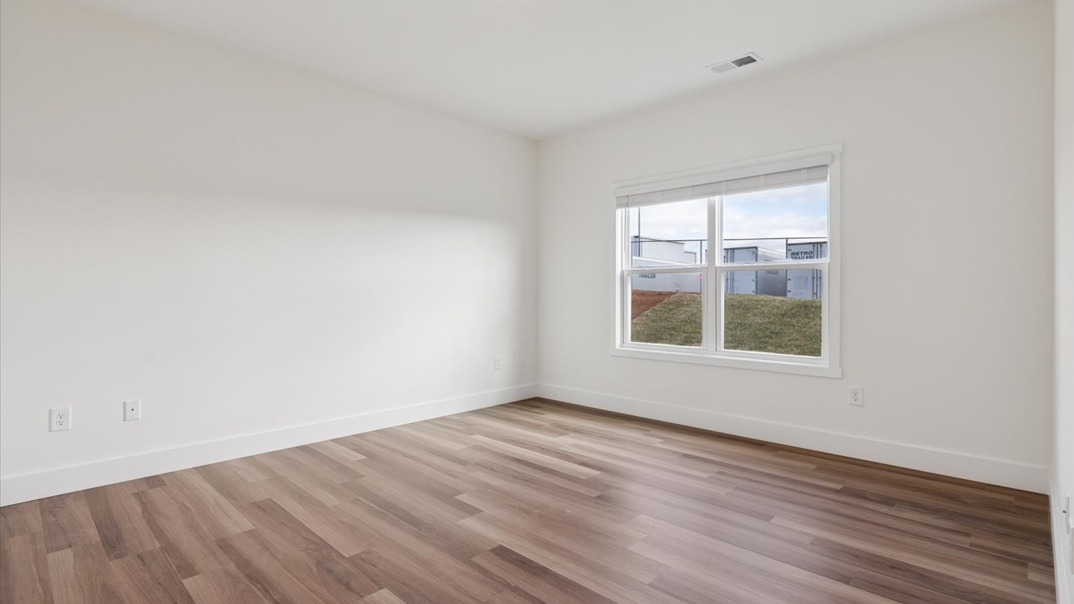 Primary bedroom with plush carpet floors and double light allowing windows