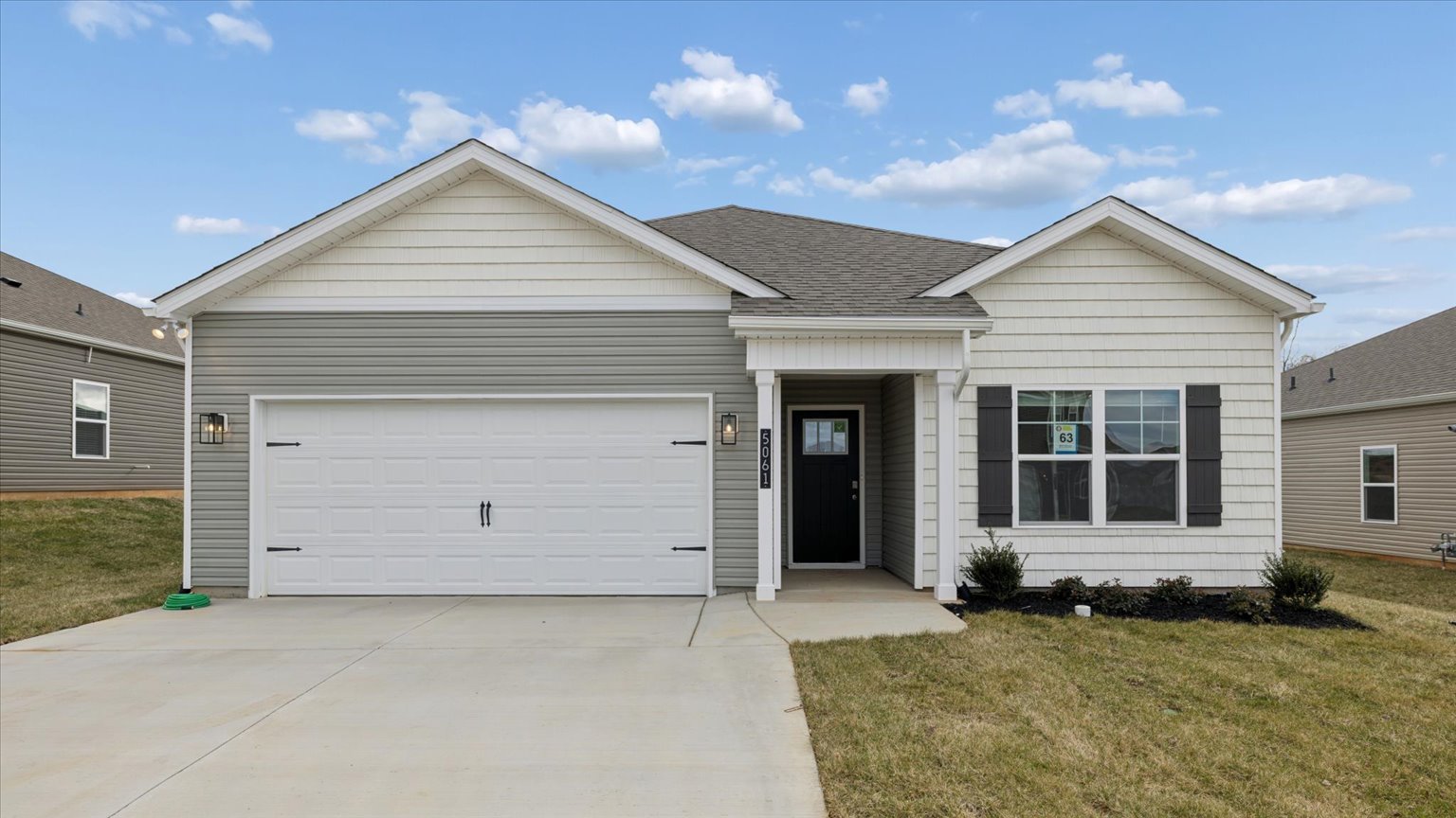 Exterior of single story ranch home with vinyl and board and batten