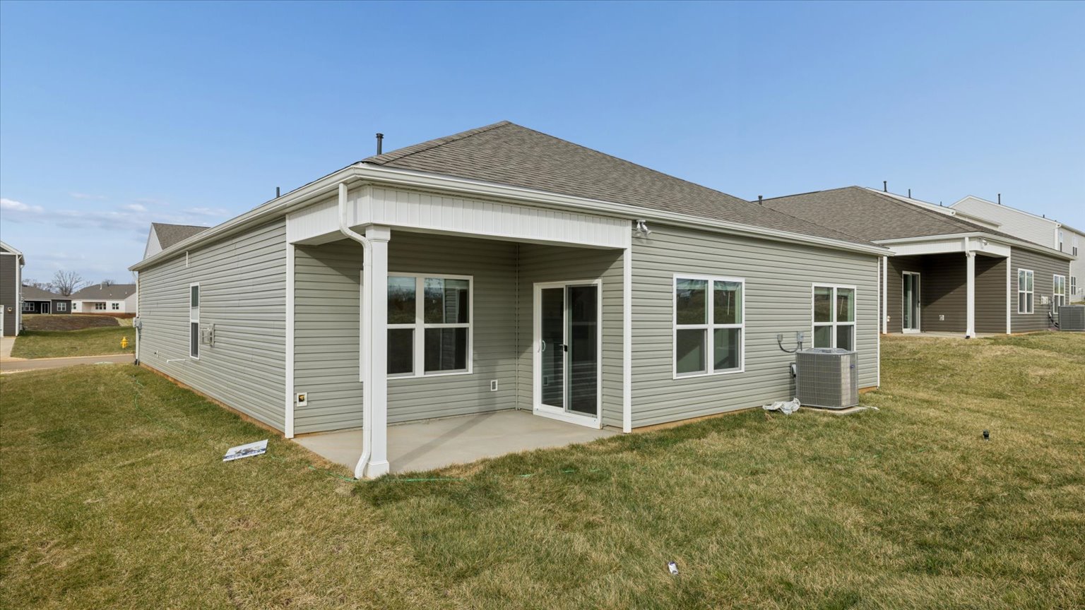 Exterior of single story ranch home with vinyl and board and batten
