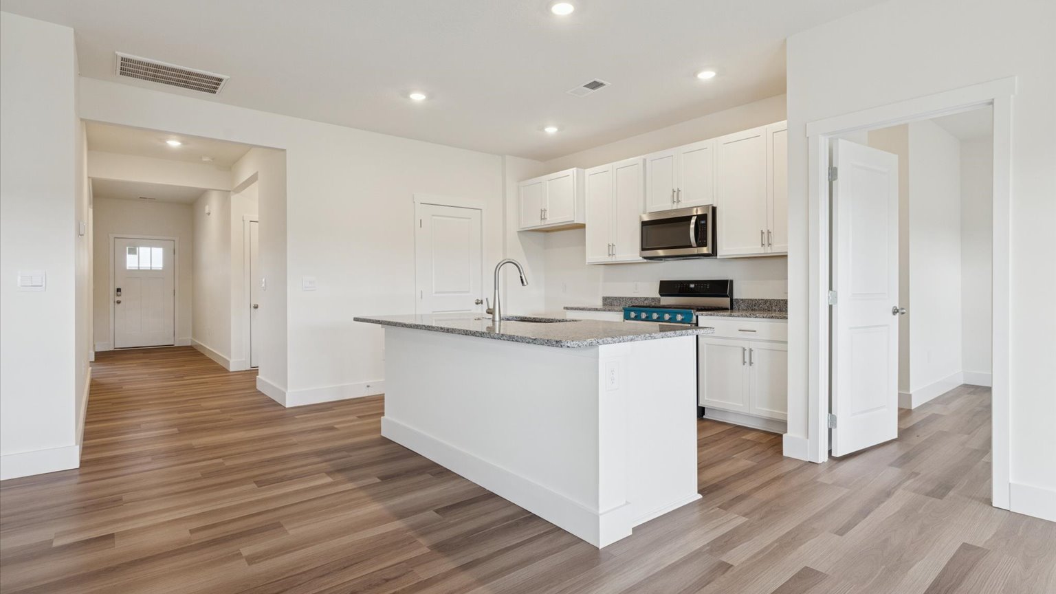 Kitchen with stainless steel appliances, shaker style cabinets, and elevated finishes