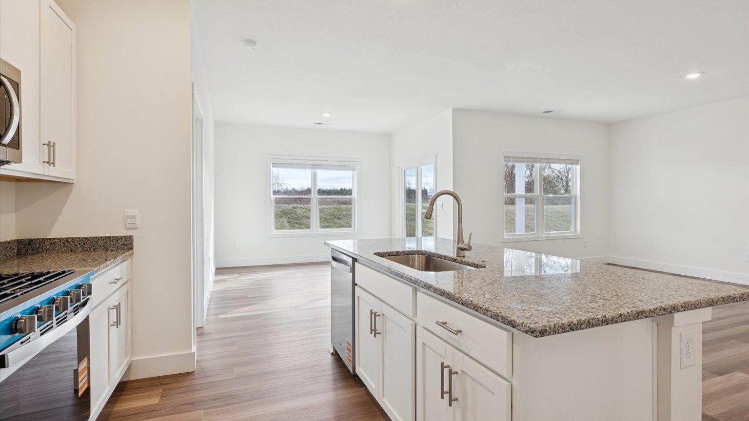 Kitchen with stainless steel appliances, shaker style cabinets, and elevated finishes