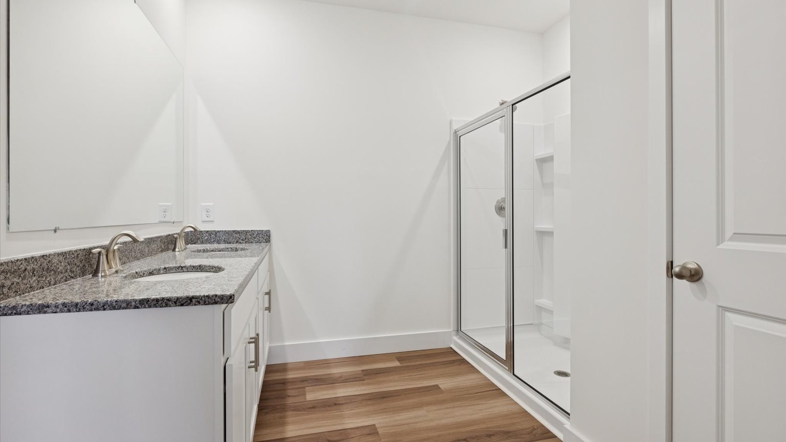 Primary bathroom with double vanity and walk-in shower