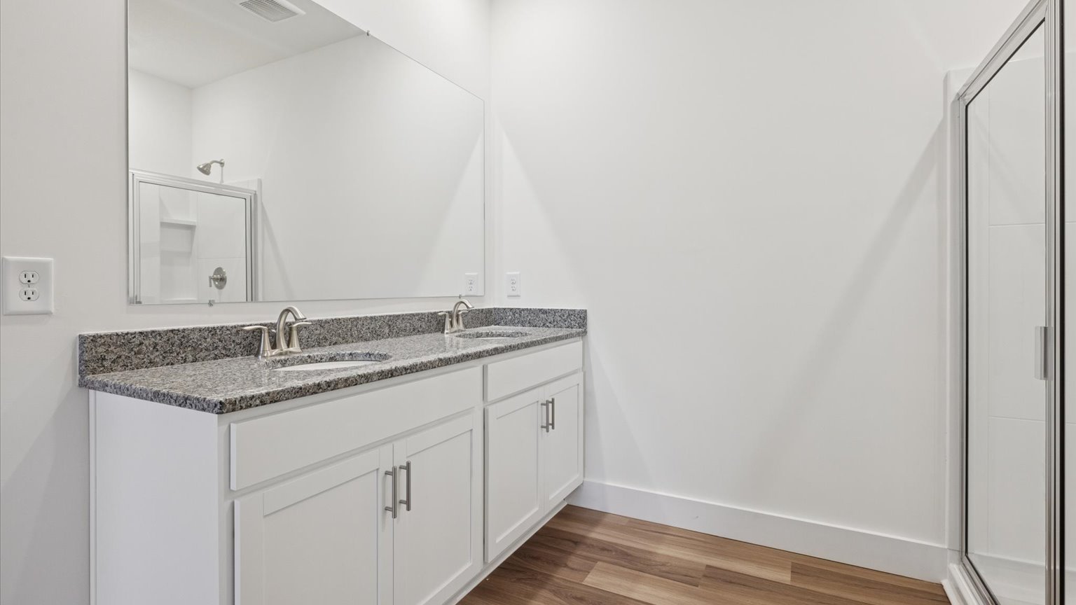 Primary bathroom with double vanity and walk-in shower