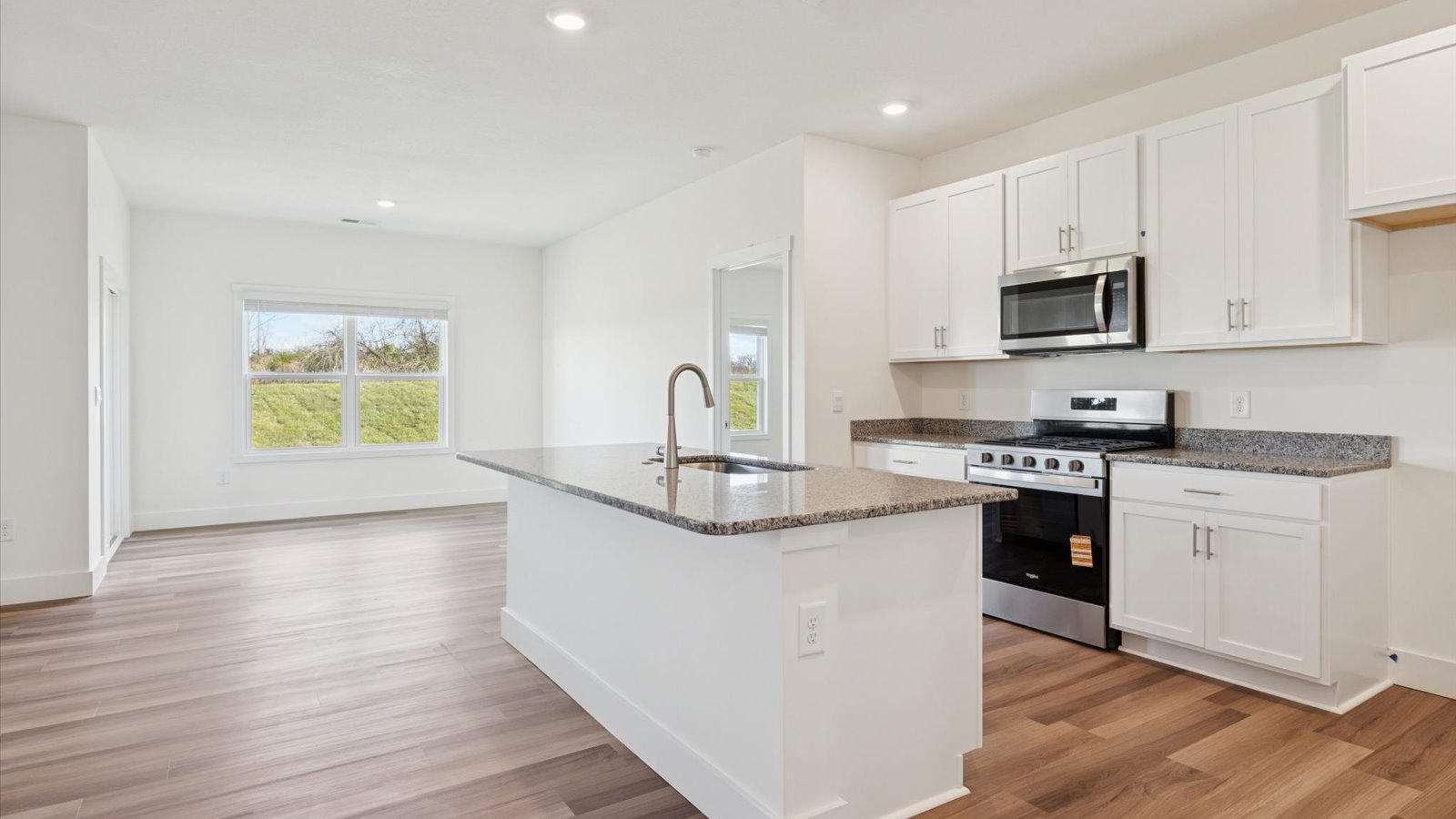 Open concept living, dining, and kitchen space