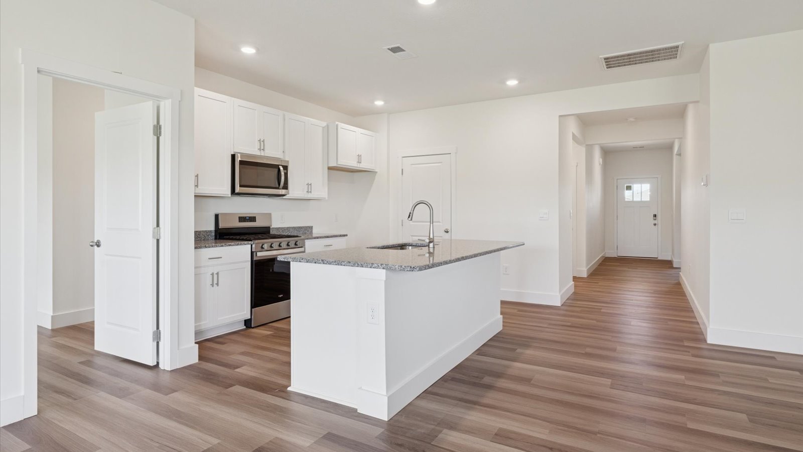 Open concept living, dining, and kitchen space