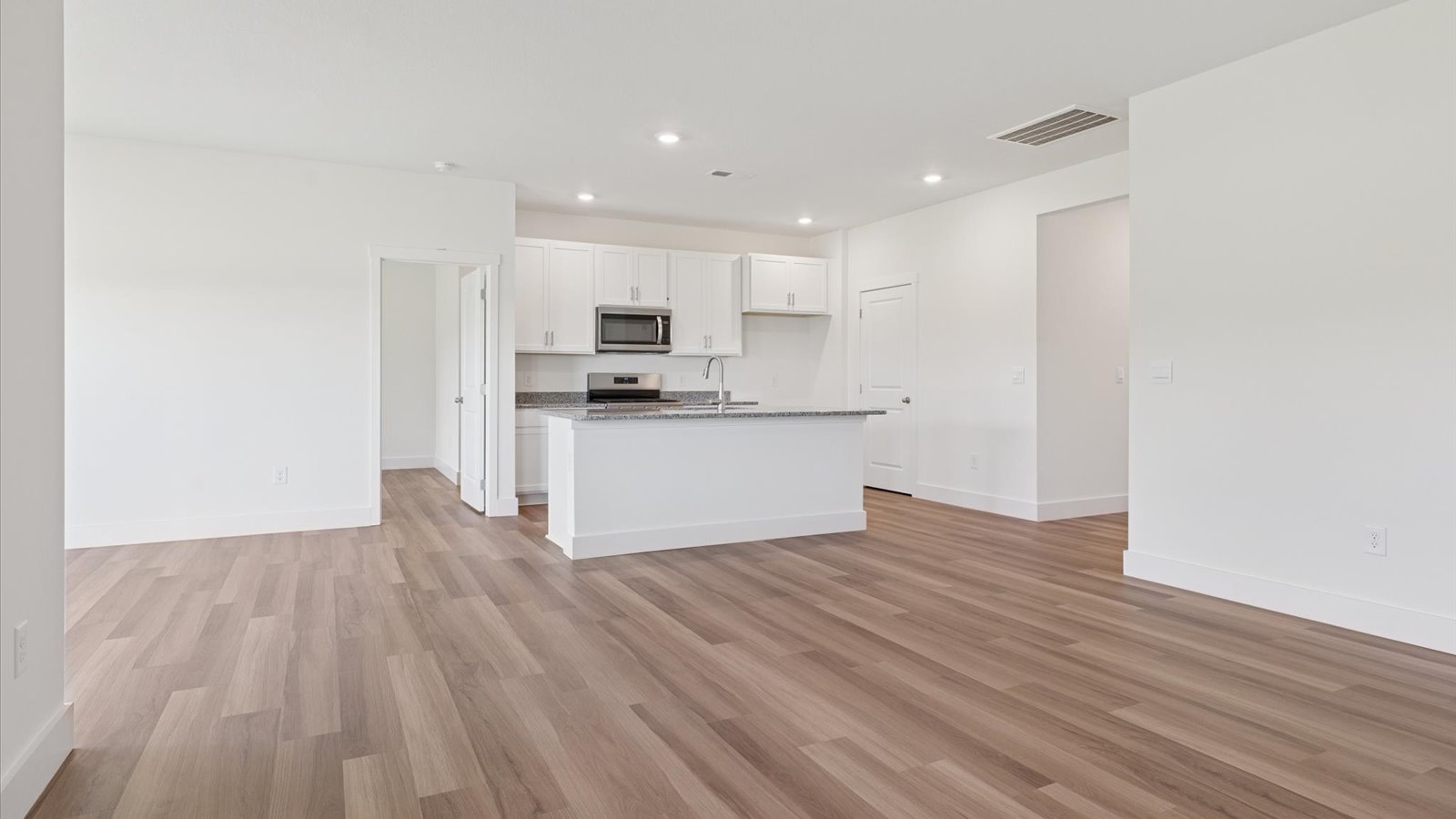 Open concept living, dining, and kitchen space