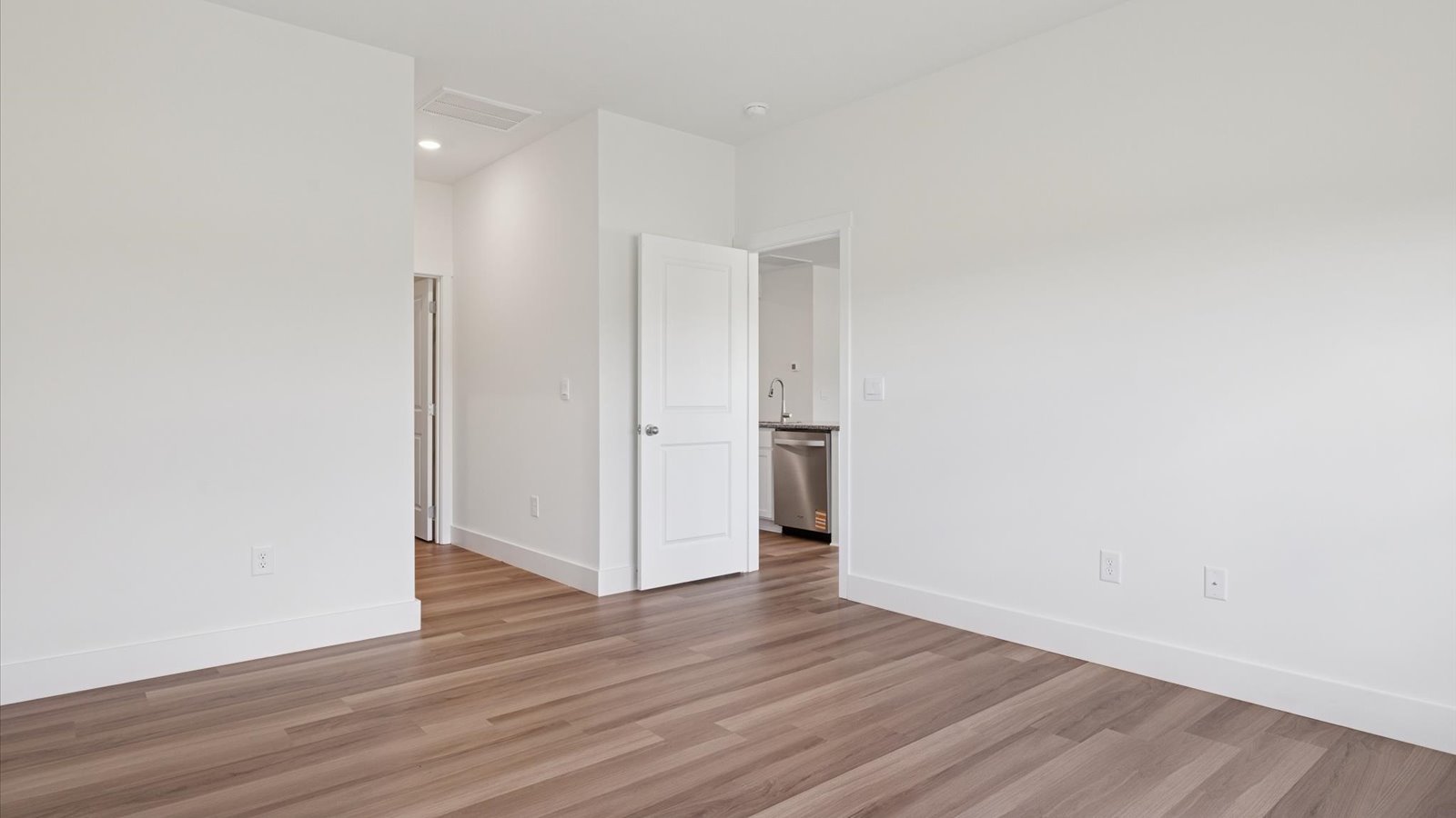 Primary bedroom with private attached bathroom and walk-in closet